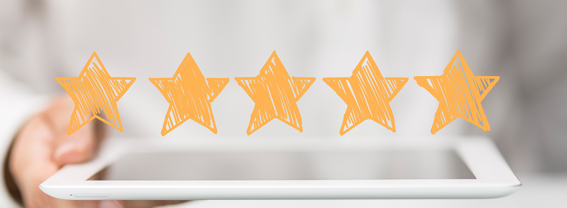 The image shows a person s hand holding a tablet with a graphic of five yellow stars, suggesting an emphasis on customer satisfaction or ratings.