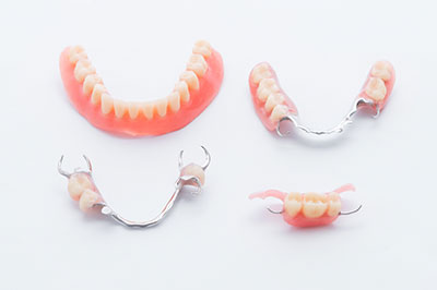 The image features a collection of dental appliances, including braces and aligners, displayed on a white background.