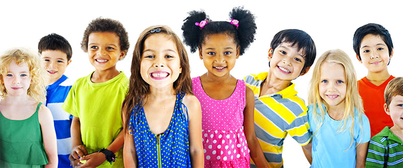 The image is a colorful group photo of children and adults, possibly from a school or community event, with a diverse range of ethnicities and attire.